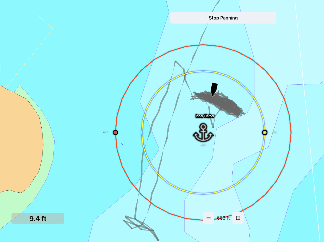 BoatKit anchor alarm screen with warning and alert geofence circles around an anchored boat.